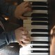The hands of a young child playing the piano