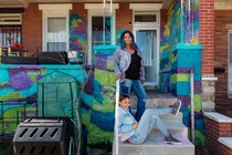 A woman and her daughter on the front steps of their home