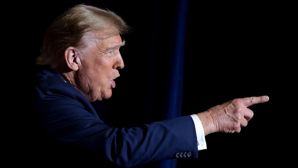 A photograph of Donald Trump pointing and talking