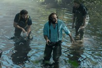 Vincent Macaigne as René the director, in the water with crew members, in 'Irma Vep'