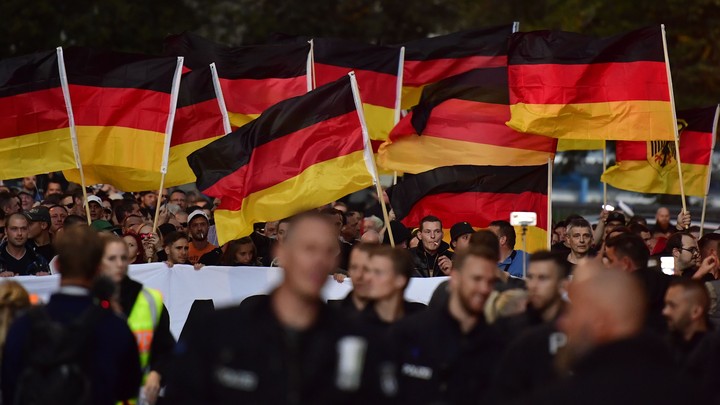 Right-wing activists hold German flags at a demonstration in Chemnitz in September.