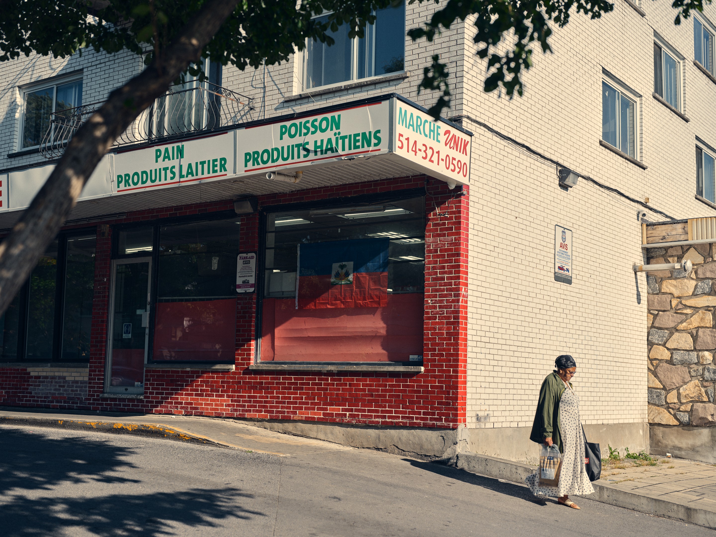 a woman walks in front of a store