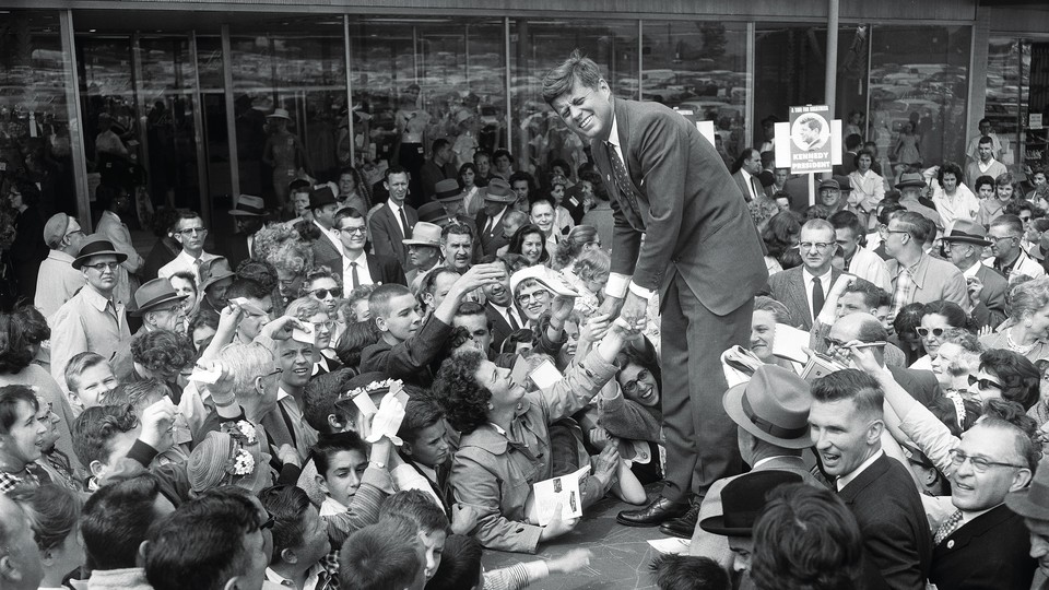 A black and white photograph of JFK campaigning at a Baltimore shopping center in the spring of 1960.