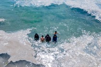 A view of the sea with people swimming, on the Asian side of Istanbul.