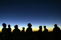 Libyan youths watch the solar eclipse in the desert tourist camp in Galo.