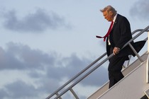 Photograph of Donald Trump walking down a staircase to exit an airplane
