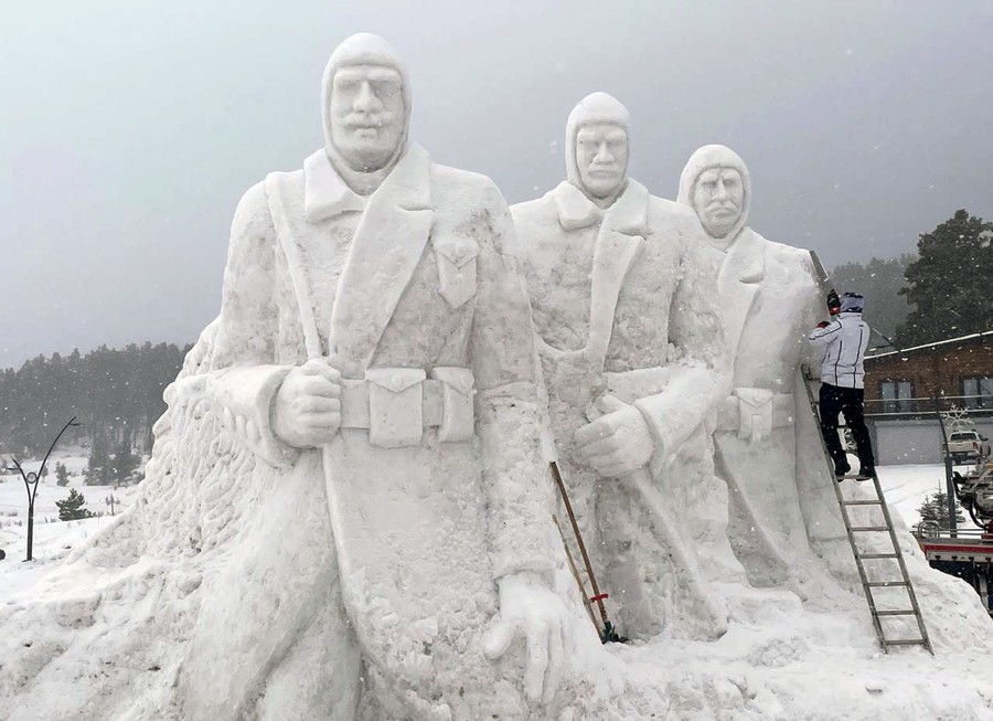 A snow sculpture featuring several large soldiers