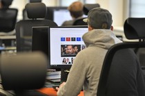 A man looking at Facebook content on a computer screen