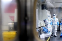People in hazmat suits working in a COVID-detection lab