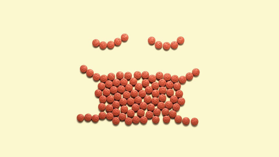 Pills in the shape of a face covered by a mask