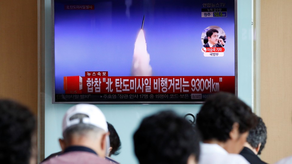 People watch a TV broadcast of North Korea's ballistic missile test in Seoul, South Korea on July 4.