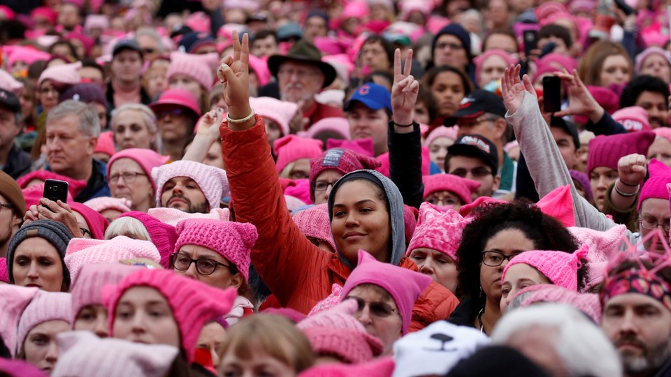 a crowd of women wearing pink hats