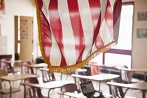 An American flag hangs above a classroom