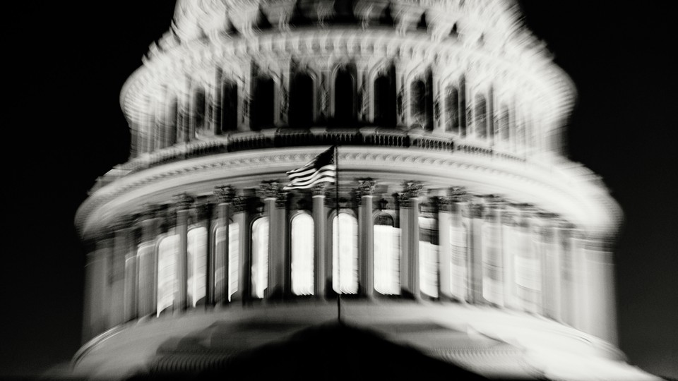 A dark and slightly blurred image of the U.S. Capitol