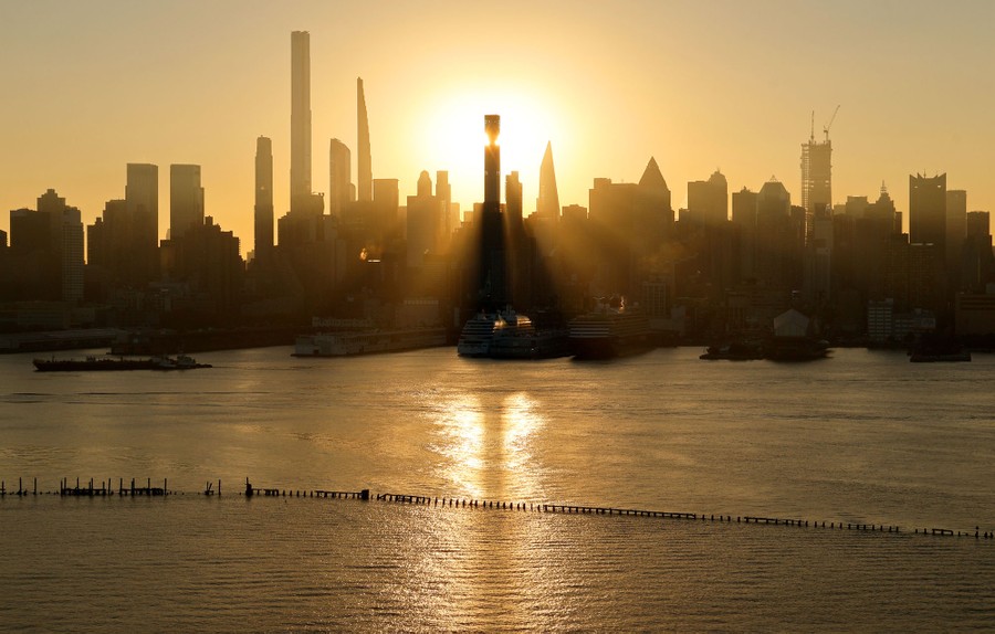 A sunrise through the New York City skyline