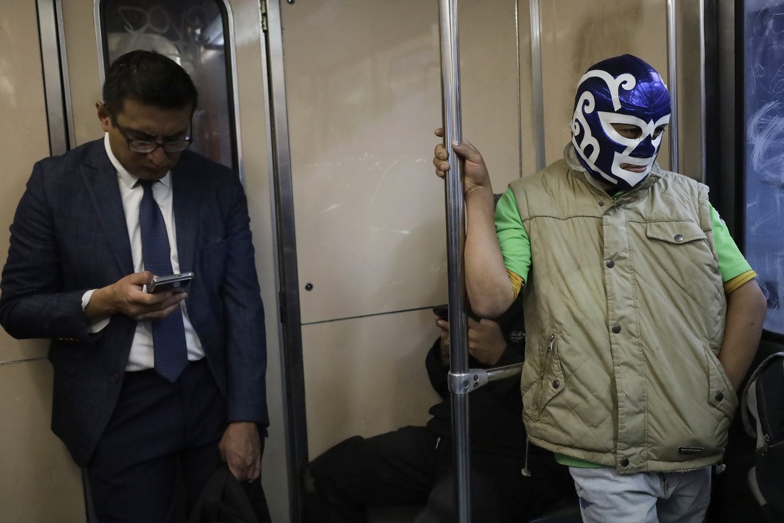 A passenger on the Mexico City Metro system wears the mask of a Mexican wrestler.