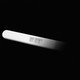 A pregnancy test coming out of the shadow of a black background