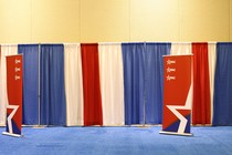 A CPAC banner and red, white, and blue curtains