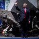 U.S. President Donald Trump waves on stage in front of a national monument before his speech in Warsaw, Poland