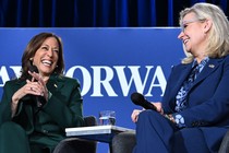 Kamala Harris and Liz Cheney laugh together at a speaking engagement