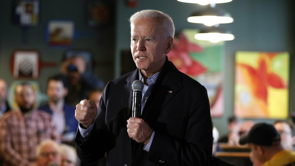 Joe Biden standing with a microphone