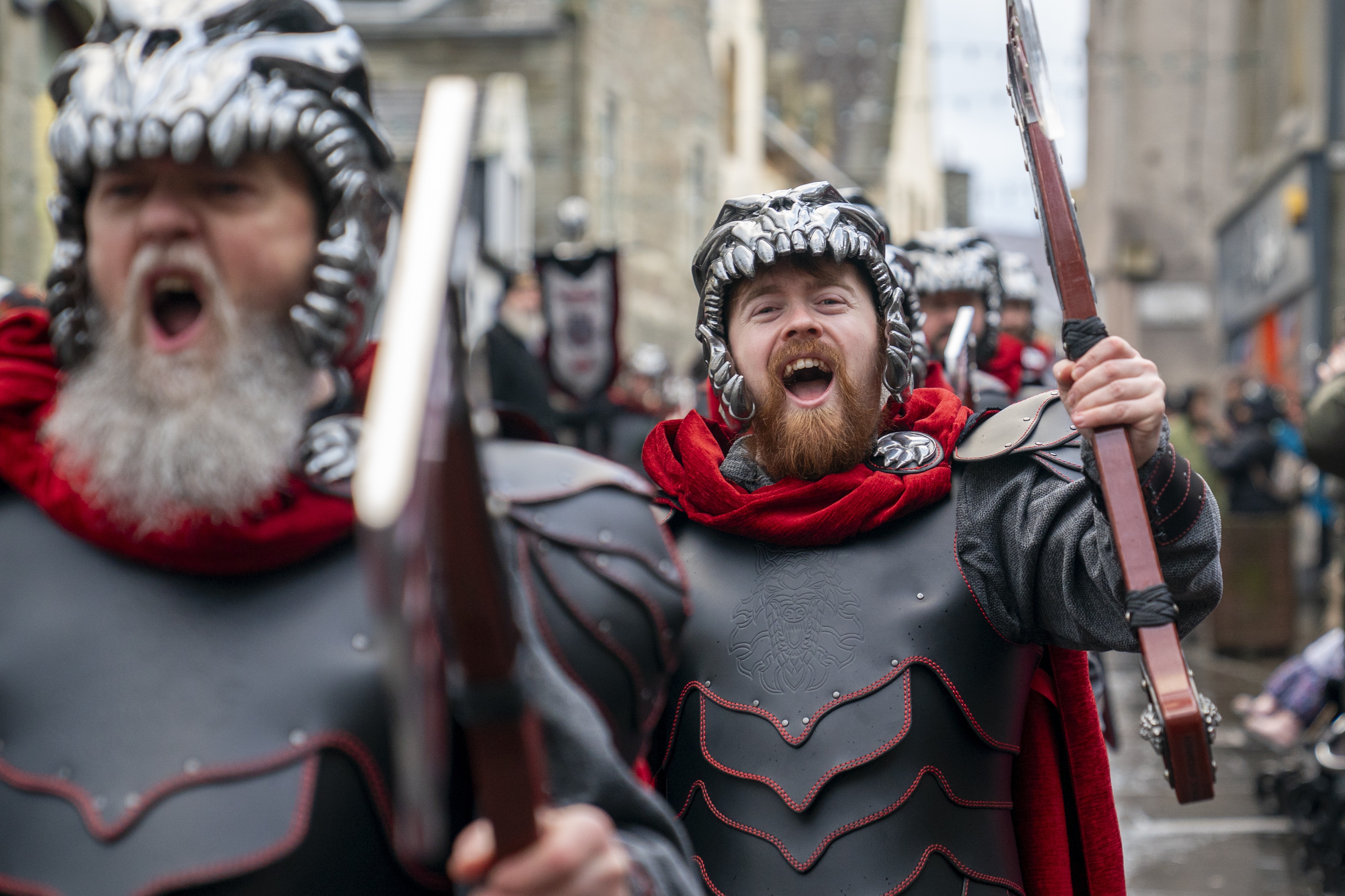 People dressed as Vikings march in a parade.