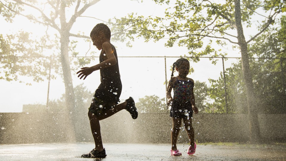 Silhouettes of children running through sprinkles