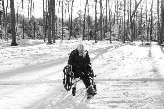 Photo of Caitlin Barber in wheelchair in snow