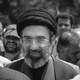 Black and white photograph of Mojtaba Khamenei in a crowd of people.