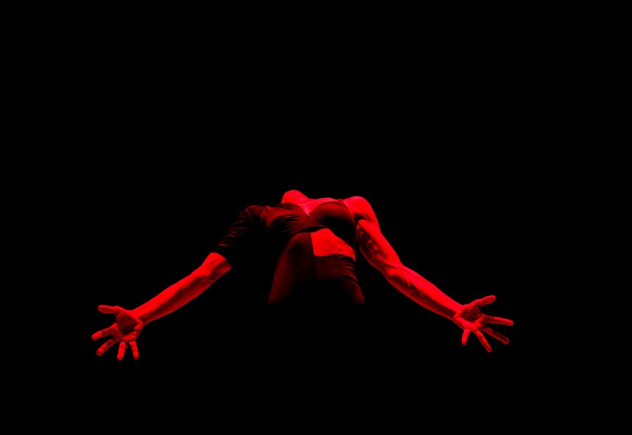 A dancer is illuminated onstage during a performance.