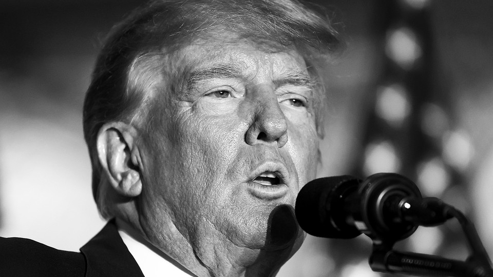 Black-and-white close-up photo of Donald Trump speaking into a microphone