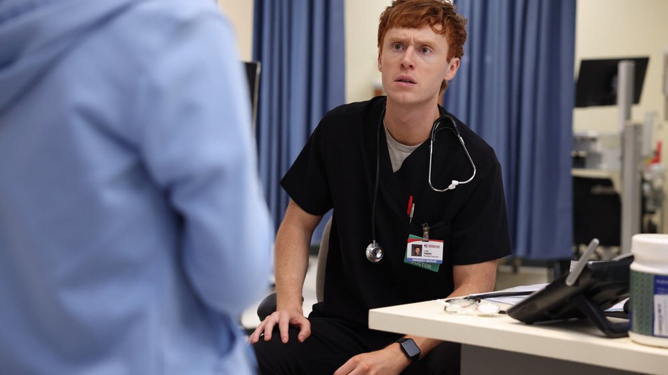 A red-headed man in a doctor's outfit looks concerned.