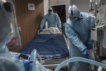 Doctors in Texas wheel a bed in a hospital