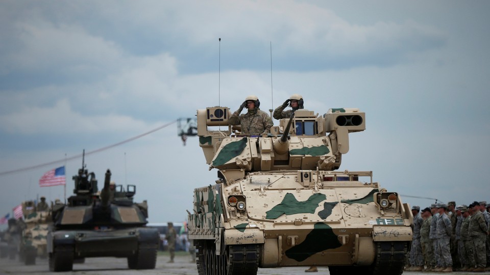 U.S. servicemen drive their armored vehicles during a joint military exercise on May 11, 2016.