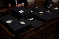 Multiple piles of executive orders on Donald Trump's desk