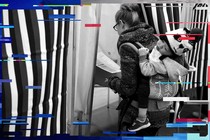 A woman with a child on her back prepares to mark her ballot in a voting booth in Bedford, New Hampshire, on February 9, 2016. 