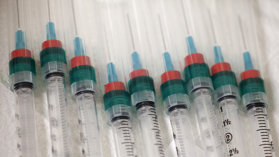 A line of syringes sits in a row