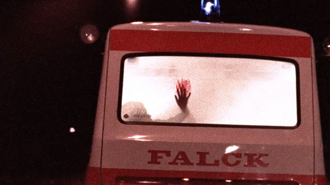A hand leaving a bloody smear from the inside of an ambulance
