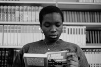 A young woman reads a book.