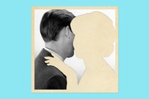 A black-and-white image of a man with an empty space where a woman might be hugging him