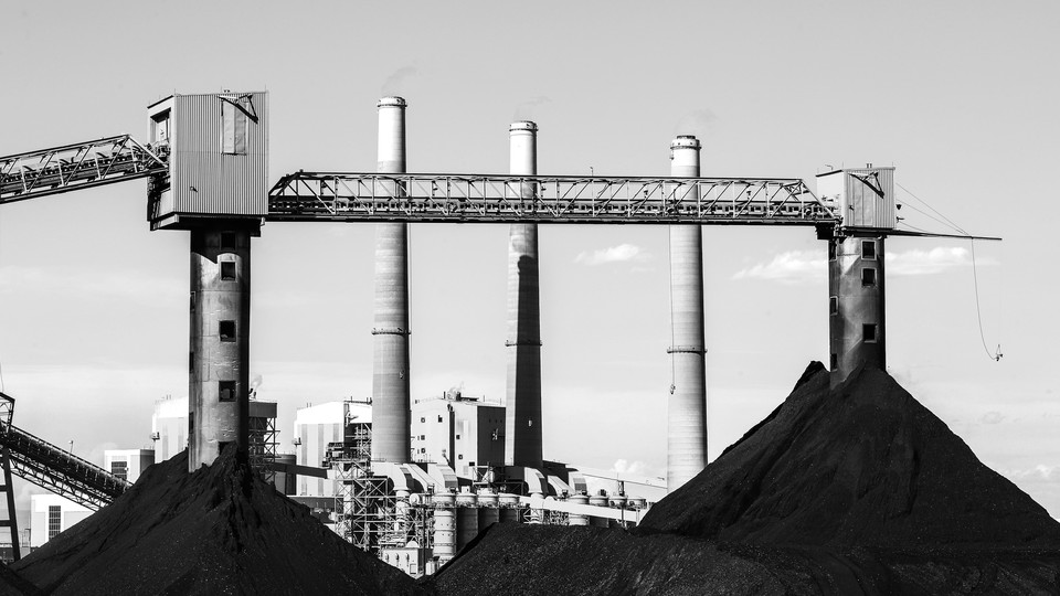 Large coal piles sit in front of PacifiCorps, a power plant in Castle Dale, Utah, in June 2019