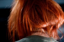 the back of a woman's head; she's wearing a read wig