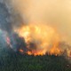 Flames reach upwards along the edge of a wildfire as seen from a Canadian Forces helicopter surveying the area near Mistissini, Quebec, Canada June 12, 2023.