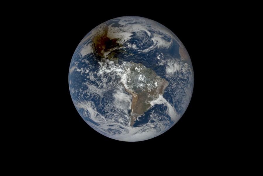 A view of the Earth, from space, with a dark blotch across part of North America—the shadow of the moon during an eclipse.