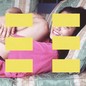 A grid of yellow rectangles superimposed over a photo of a girl hugging her legs on a couch