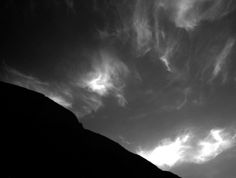 Wispy clouds are seen in the Martian sky.