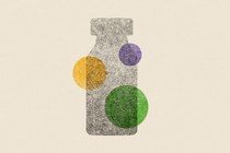 a gray vaccine vial covered in three dots of different colors