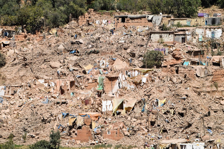 Many destroyed houses cover a hillside.