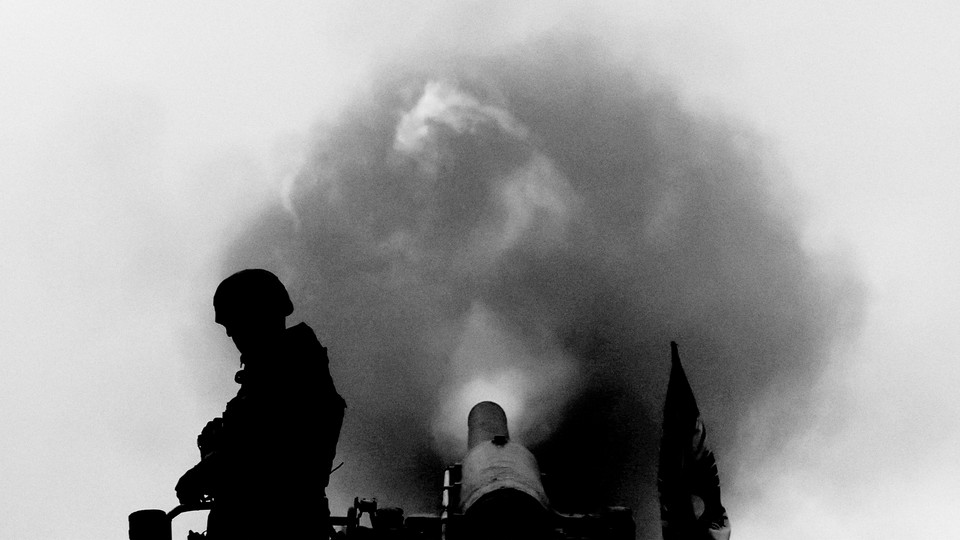 Picture showing the silhouette of a soldier next to a missile and a cloud of smoke