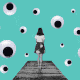 A woman in a skirt stands on a dock alone, while googly eyes move around her